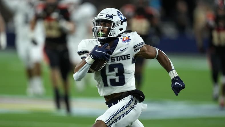 Dec 18, 2021; Inglewood, CA, USA; Utah State Aggies wide receiver Deven Thompkins (13) scores on a 62-yard touchdown reception against the Oregon State Beavers in the first half of the 2021 LA Bowl at SoFi Stadium. Mandatory Credit: Kirby Lee-USA TODAY Sports