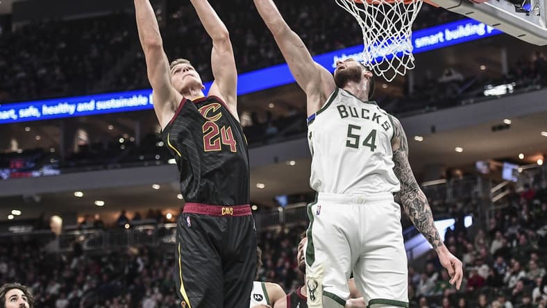 Dec 18, 2021; Milwaukee, Wisconsin, USA; Cleveland Cavaliers forward Lauri Markkanen (24) shoots the ball against Milwaukee Bucks forward Sandro Mamukelashvili (54) in the second quarter at Fiserv Forum. Mandatory Credit: Benny Sieu-USA TODAY Sports