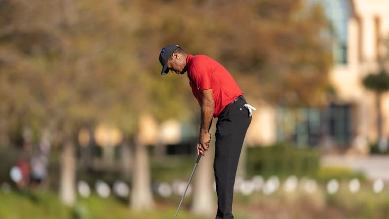 Dec 19, 2021; Orlando, Florida, USA; Tiger Woods putts on the 18th green during the final round of the PNC Championship golf tournament at Grande Lakes Orlando Course. Mandatory Credit: Jeremy Reper-USA TODAY Sports