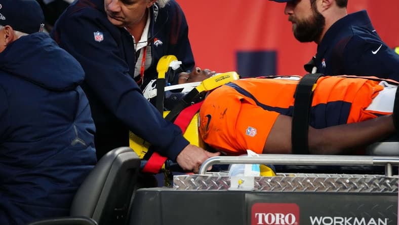 Dec 19, 2021; Denver, Colorado, USA; Denver Broncos quarterback Teddy Bridgewater (5) is carted off the field in the third quarter against the Cincinnati Bengals at Empower Field at Mile High Mandatory Credit: Ron Chenoy-USA TODAY Sports
