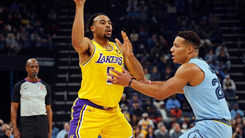 Dec 9, 2021; Memphis, Tennessee, USA; Los Angeles Lakers guard Talen Horton-Tucker (5) passes the ball as Memphis Grizzles guard Desmond Bane (22) defends during the first half at FedExForum. Mandatory Credit: Petre Thomas-USA TODAY Sports