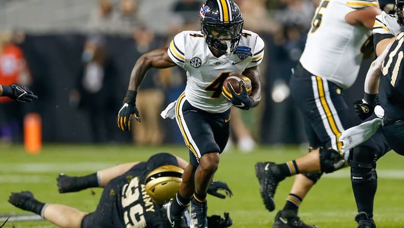 Dec 22, 2021; Fort Worth, Texas, USA; Missouri Tigers running back Elijah Young (4) breaks through a hole in the line against the Missouri Tigers during the first quarter of the 2021 Armed Forces Bowl at Amon G. Carter Stadium. Mandatory Credit: Andrew Dieb-USA TODAY Sports