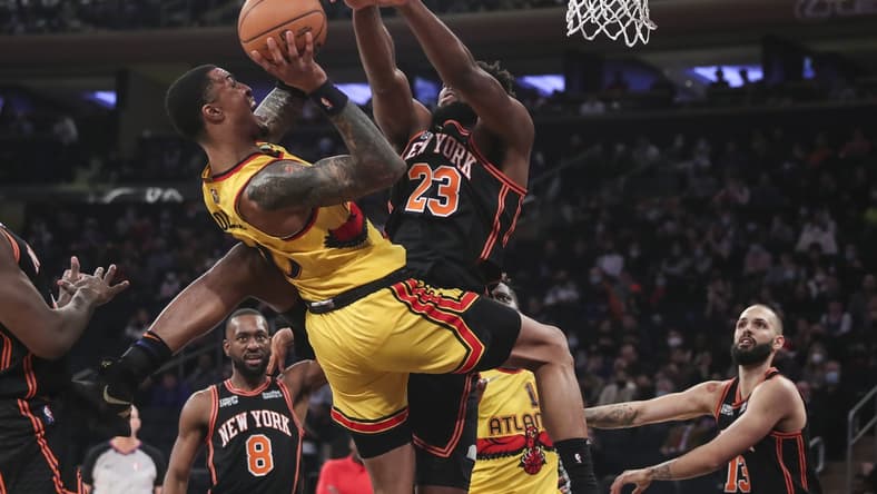 Dec 25, 2021; New York, New York, USA; Atlanta Hawks forward John Collins (20) goes up against New York Knicks center Mitchell Robinson (23) in the first quarter at Madison Square Garden. Mandatory Credit: Wendell Cruz-USA TODAY Sports