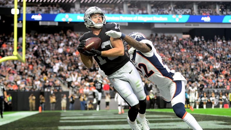 Dec 26, 2021; Paradise, Nevada, USA; Las Vegas Raiders wide receiver Hunter Renfrow (13) makes a touchdown catch against Denver Broncos safety Kareem Jackson (22) during the first half at Allegiant Stadium. Mandatory Credit: Joe Camporeale-USA TODAY Sports