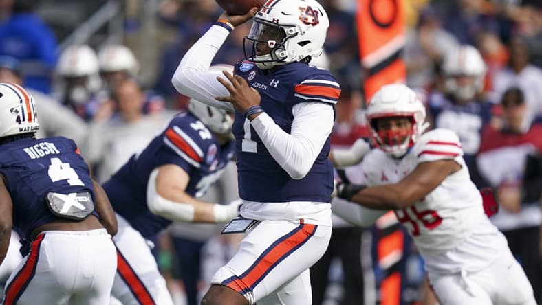 Dec 28, 2021; Birmingham, Alabama, USA; Auburn Tigers quarterback TJ Finley (1) passes against the Houston Cougars during the first half of the 2021 Birmingham Bowl at Protective Stadium. Mandatory Credit: Marvin Gentry-USA TODAY Sports