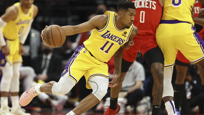 Dec 28, 2021; Houston, Texas, USA; Los Angeles Lakers guard Malik Monk (11) attempts to dribble the ball around Houston Rockets guard Jalen Green (0) during the first quarter at Toyota Center. Mandatory Credit: Troy Taormina-USA TODAY Sports