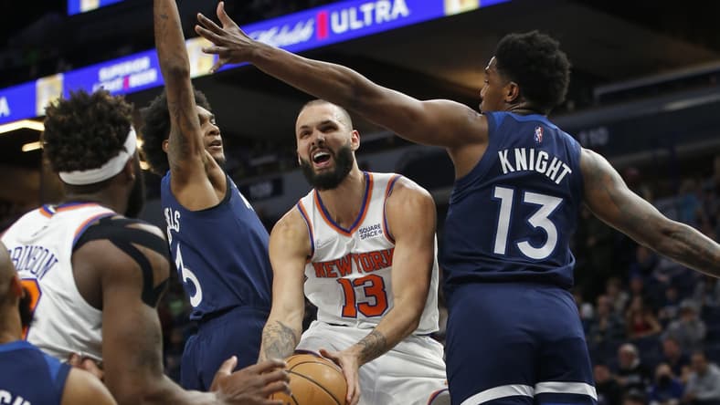 Dec 28, 2021; Minneapolis, Minnesota, USA; New York Knicks guard Evan Fournier (13) works between Minnesota Timberwolves forward Jaden McDaniels (3) and forward Nathan Knight (13) to shoot the ball in the first quarter at Target Center. Mandatory Credit: Bruce Kluckhohn-USA TODAY Sports
