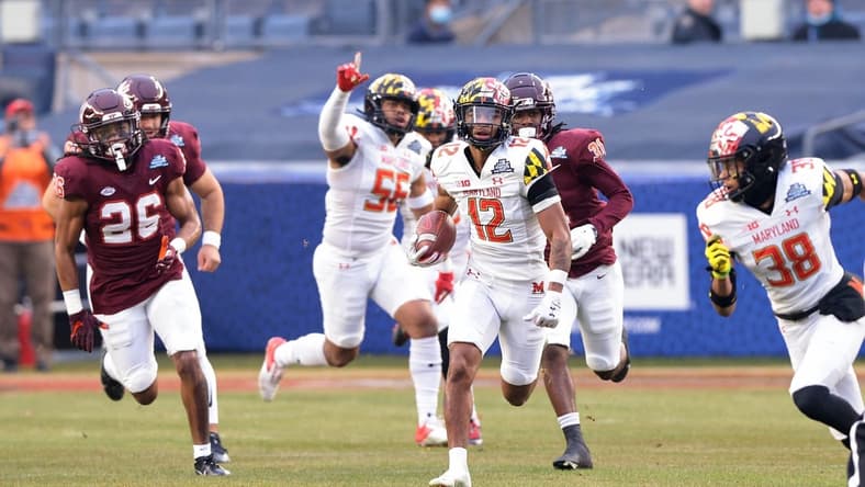 Dec 29, 2021; New York, NY, USA; Maryland Terrapins punt returner Tarheeb Still (12) returns a punt for a touchdown during the first half during the 2021 Pinstripe Bowl against the Virginia Tech Hokies at Yankee Stadium. Mandatory Credit: Vincent Carchietta-USA TODAY Sports