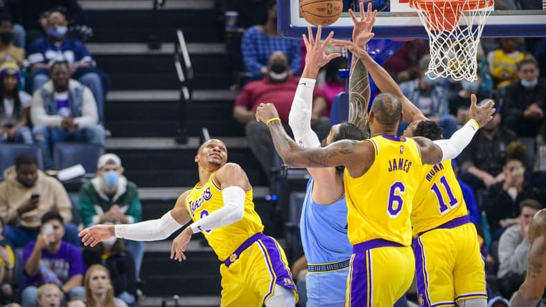 Dec 29, 2021; Memphis, Tennessee, USA; Los Angeles Lakers guard Russell Westbrook (0) and forward LeBron James (6) and guard Malik Monk (11) fight for the rebound with Memphis Grizzlies center Steven Adams (4) during the first quarter at the FedExForum. Mandatory Credit: Jerome Miron-USA TODAY Sports