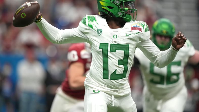 Dec 29, 2021; San Antonio, Texas, USA; Oregon Ducks quarterback Anthony Brown (13) throws the ball against the Oklahoma Sooners in the first half of the 2021 Alamo Bowl at Alamodome. Mandatory Credit: Kirby Lee-USA TODAY Sports