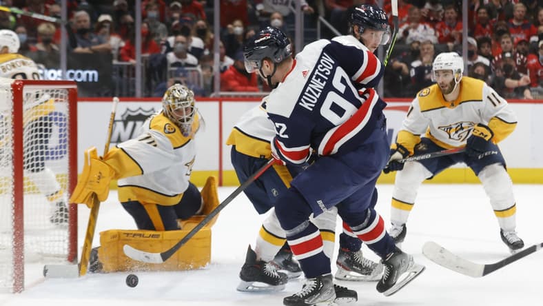 Dec 29, 2021; Washington, District of Columbia, USA; Washington Capitals center Evgeny Kuznetsov (92) shoots the puck on Nashville Predators goaltender Juuse Saros (74) during the third period at Capital One Arena. Mandatory Credit: Geoff Burke-USA TODAY Sports