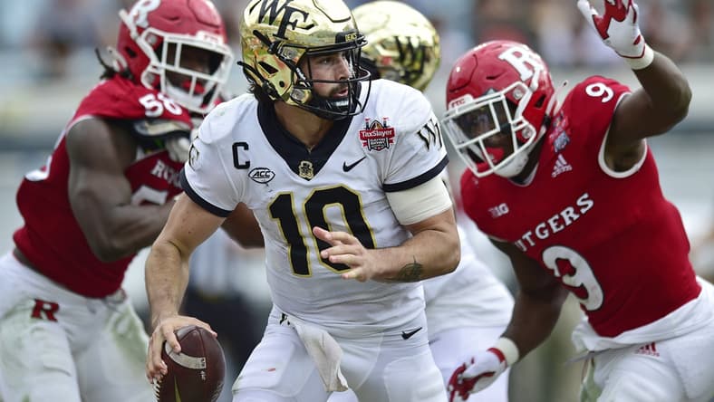 Wake Forest Demon Deacons quarterback Sam Hartman (10) is pressured in the pocket during the second quarter Friday, Dec. 31, 2021 at TIAA Bank Field in Jacksonville. The Wake Forest Demon Deacons and the Rutgers Scarlet Knights faced each other in the 2021 TaxSlayer Gator Bowl. [Corey Perrine/Florida Times-Union]