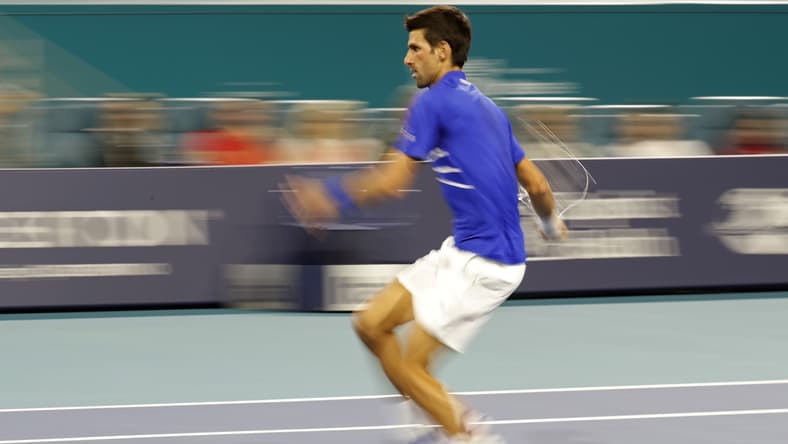 Mar 22, 2019; Miami Gardens, FL, USA; Novak Djokovic of Serbia hits a forehand against Bernard Tomic of Australia (not pictured) in the second round of the Miami Open at Miami Open Tennis Complex. Mandatory Credit: Geoff Burke-USA TODAY Sports