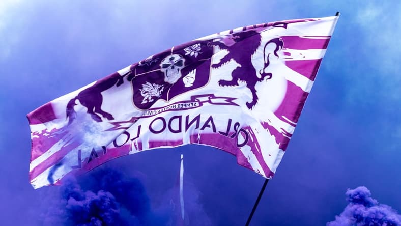 Mar 31, 2019; Orlando, FL, USA; General view of Orlando City fans waving a flag while marching to the stadium prior to the game between the Orlando City and the D.C. United at Orlando City Stadium. Mandatory Credit: Douglas DeFelice-USA TODAY Sports