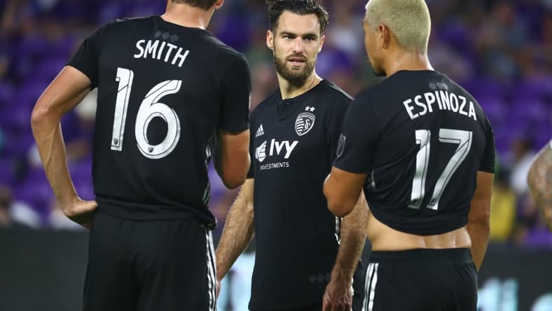 Aug 14, 2019; Orlando, FL, USA; Sporting Kansas City midfielder Graham Zusi (8), midfielder Graham Smith (16) and midfielder Roger Espinoza (17) talk against the Orlando City SC during the first half at Exploria Stadium. Mandatory Credit: Kim Klement-USA TODAY Sports