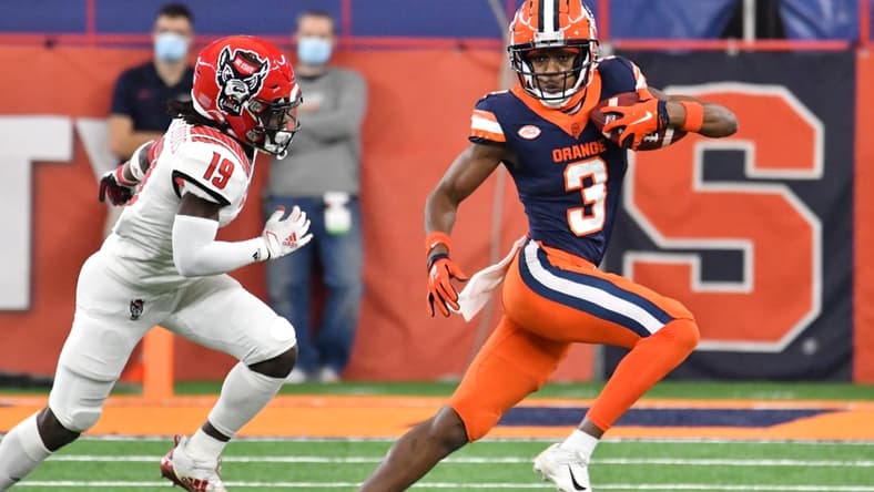Nov 28, 2020; Syracuse, New York, USA; Syracuse Orange wide receiver Taj Harris (3) runs from North Carolina State Wolfpack defensive back Joshua Pierre-Louis (19) after making a catch in the second quarter at the Carrier Dome. Mandatory Credit: Mark Konezny-USA TODAY Sports