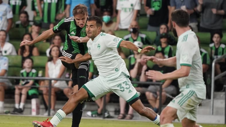 Jul 31, 2021; Austin, TX, USA; Austin FC midfielder Tom s Pochettino (7) shoots on goal through Colorado Rapids defender Steven Beitashour (33) in the second half at Q2 Stadium. Mandatory Credit: Scott Wachter-USA TODAY Sports