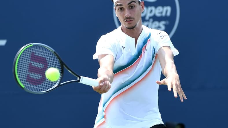 Aug 9, 2021; Toronto, Ontario, Canada; Lorenzo Sonego of Italy plays a shot against Ugo Humbert of France in first round play at Aviva Centre. Mandatory Credit: Dan Hamilton-USA TODAY Sports