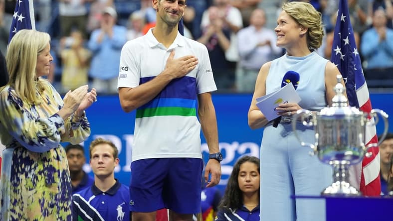 Sep 12, 2021; Flushing, NY, USA; Novak Djokovic of Serbia acknowledges the crowd during an interview with ESPN host Chris McKendry (R) during the trophy ceremony after his match against Daniil Medvedev of Russia (not pictured) in the men's singles final on day fourteen of the 2021 U.S. Open tennis tournament at USTA Billie Jean King National Tennis Center. Mandatory Credit: Danielle Parhizkaran-USA TODAY Sports