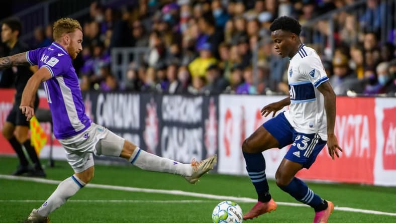 Aug 26, 2021; Victoria, British Columbia, Canada;  Pacific FC forward Josh Heard (11) reaches for the ball against Vancouver Whitecaps defender Javain Brown (23) during the second half at the Starlight Stadium. Mandatory Credit: Anne-Marie Sorvin-USA TODAY Sports
