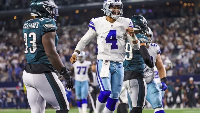 Sep 27, 2021; Arlington, Texas, USA; Dallas Cowboys quarterback Dak Prescott (4) celebrates a touchdown during the fourth quarter as Philadelphia Eagles defensive tackle Milton Williams (93) looks on at AT&T Stadium. Mandatory Credit: Kevin Jairaj-USA TODAY Sports