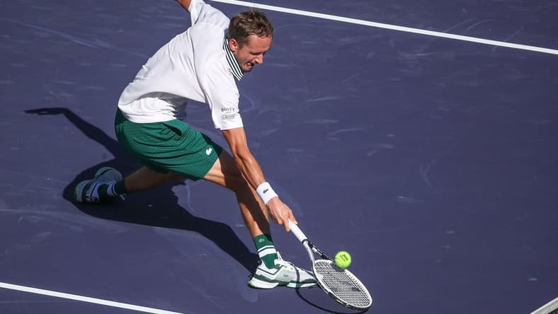 Daniil Medvedev reaches for a shot at the net but double hits it during his match against Grigor Dimitrov at the BNP Paribas Open in Indian Wells, October 13, 2021.

Bnp Wed 1