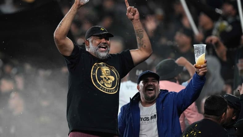Oct 26, 2021; Los Angeles, California, USA; LAFC fans hold react in the first half against the Seattle Sounders at Banc of California Stadium. Mandatory Credit: Kirby Lee-USA TODAY Sports