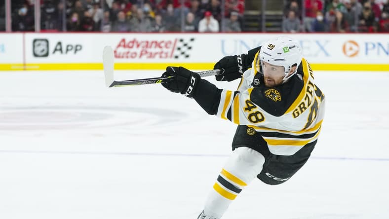 Oct 28, 2021; Raleigh, North Carolina, USA; Boston Bruins defenseman Matt Grzelcyk (48) takes a slap shot during the third period against the Carolina Hurricanes at PNC Arena. Mandatory Credit: James Guillory-USA TODAY Sports