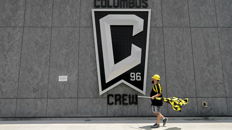 Nick Auddino, of Westerville, walks in front of a Columbus Crew logo on the west side of Lower.com Field before attending the inaugural match between the Columbus Crew and the New England Revolution in Columbus on Saturday, June 1, 2021. Auddino is a longtime Crew supporter who has only missed one game for the birth of his son. His children Jordan, 12, and Laina, 6, Auddino, were attending the match with him.

Ceb Crew 0705 Bjp 01