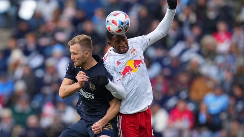 Nov 20, 2021; Chester, PA, USA; Philadelphia Union forward Kacper Przybylko (23) and New York Red Bulls defender Andres Reyes (4) attempt to play the ball off their heads in a round one MLS Playoff game at Subaru Park. Mandatory Credit: Mitchell Leff-USA TODAY Sports