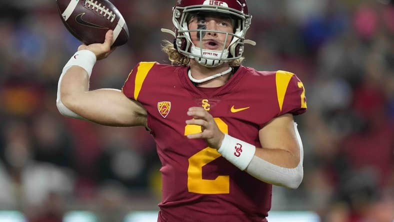 Nov 27, 2021; Los Angeles, California, USA; Southern California Trojans quarterback Jaxson Dart (2) throws the ball against the BYU Cougars in the first half at United Airlines Field at Los Angeles Memorial Coliseum. Mandatory Credit: Kirby Lee-USA TODAY Sports