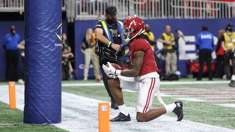 Dec 4, 2021; Atlanta, GA, USA; Alabama Crimson Tide wide receiver Jameson Williams (1) celebrates at the goal post after a receiving touchdown during the third quarter against the Georgia Bulldogs during the SEC championship game at Mercedes-Benz Stadium. Mandatory Credit: Jason Getz-USA TODAY Sports