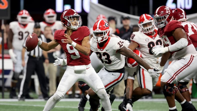 Dec 4, 2021; Atlanta, GA, USA; Alabama Crimson Tide quarterback Bryce Young (9) attempts a pass against Georgia Bulldogs linebacker Robert Beal Jr. (33) during the second quarter of the SEC championship game at Mercedes-Benz Stadium. Mandatory Credit: Jason Getz-USA TODAY Sports