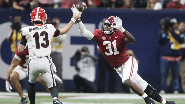 Dec 4, 2021; Atlanta, GA, USA; Georgia Bulldogs quarterback Stetson Bennett (13) throws a pass against Alabama Crimson Tide linebacker Will Anderson Jr. (31) during the SEC championship game at Mercedes-Benz Stadium. Alabama won 41-24. Mandatory Credit: Gary Cosby Jr.-USA TODAY Sports