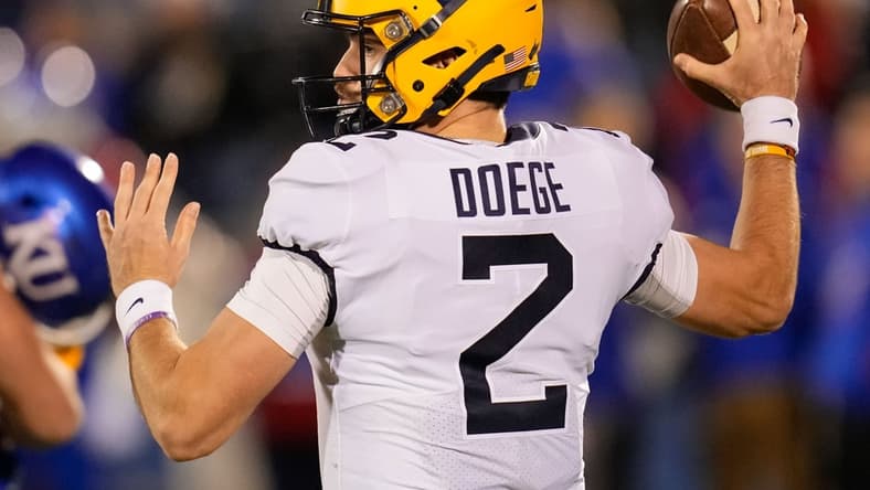 Nov 27, 2021; Lawrence, Kansas, USA; West Virginia Mountaineers quarterback Jarret Doege (2) throws a pass against the Kansas Jayhawks during the first half at David Booth Kansas Memorial Stadium. Mandatory Credit: Jay Biggerstaff-USA TODAY Sports