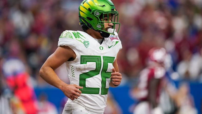 Dec 29, 2021; San Antonio, Texas, USA; Oregon Ducks running back Travis Dye (26) runs off the field after scoring a touchdown during the second half of the 2021 Alamo Bowl against he Oklahoma Sooners at the Alamodome. Mandatory Credit: Daniel Dunn-USA TODAY Sports