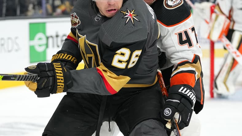 Dec 31, 2021; Las Vegas, Nevada, USA; Anaheim Ducks defenseman Hampus Lindholm (47) tips the puck away from Vegas Golden Knights center Mattias Janmark (26) during the second period at T-Mobile Arena. Mandatory Credit: Stephen R. Sylvanie-USA TODAY Sports