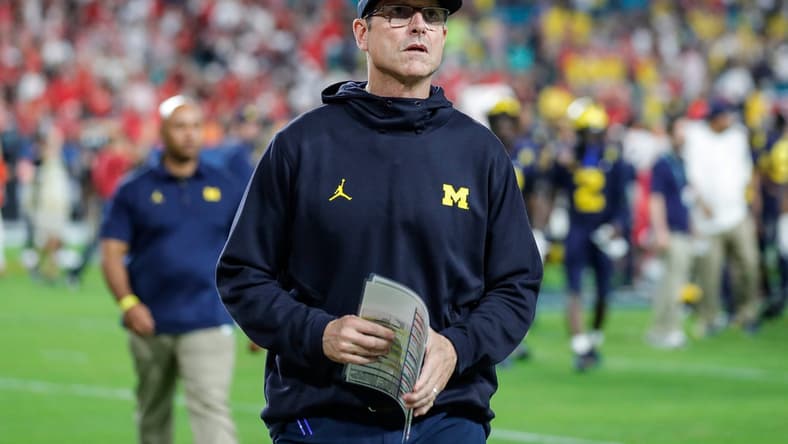 Michigan head coach Jim Harbaugh walks off the field after the Wolverines' 34-11 loss to the Georgia Bulldogs in the Orange Bowl.

Syndication Detroit Free Press