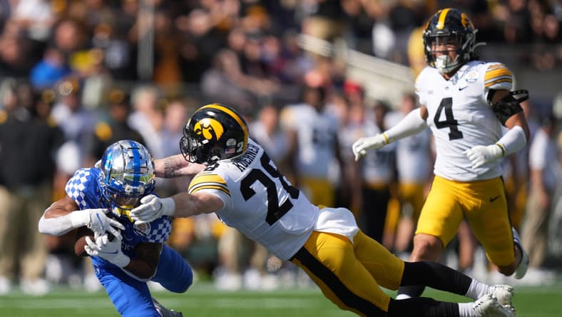 Jan 1, 2022; Orlando, FL, USA; Kentucky Wildcats wide receiver Wan'Dale Robinson (1) makes a diving catch against Iowa Hawkeyes defensive back Jack Koerner (28) during first half in the 2022 Citrus Bowl at Camping World Stadium. Mandatory Credit: Jasen Vinlove-USA TODAY Sports
