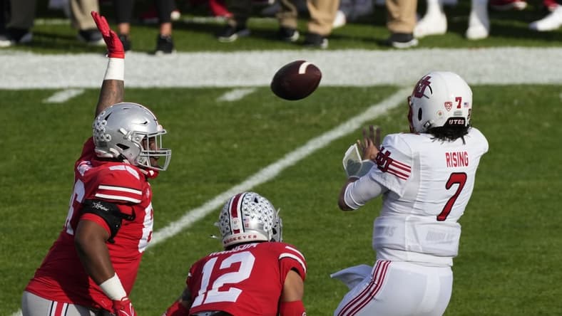 Jan 1, 2022; Pasadena, California, USA; Utah Utes quarterback Cameron Rising (7) gets off a pass pressured by Ohio State Buckeyes defensive tackle Jerron Cage (86) and Ohio State Buckeyes safety Lathan Ransom (12) during the first quarter of the 2022 Rose Bowl at Rose Bowl. Mandatory Credit: Robert Hanashiro-USA TODAY Sports