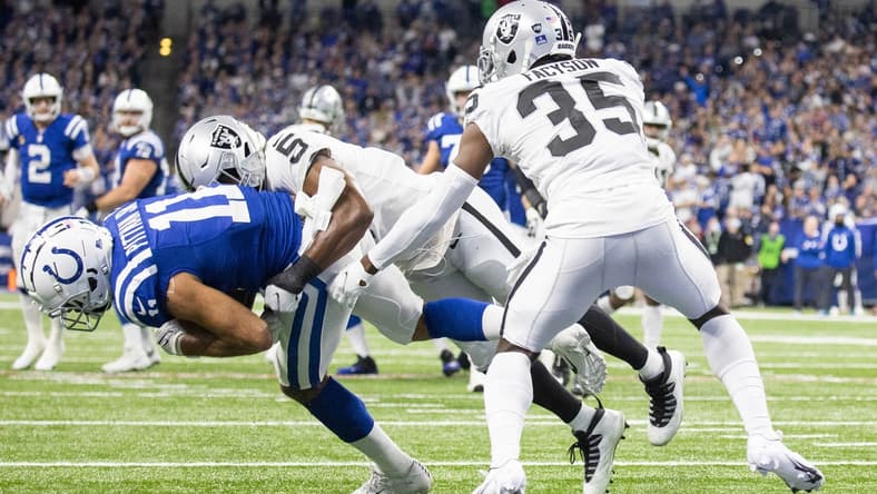 Jan 2, 2022; Indianapolis, Indiana, USA; Indianapolis Colts wide receiver Michael Pittman (11) catches the ball and is stopped on the one yard line by Las Vegas Raiders linebacker Divine Deablo (5) in the first half at Lucas Oil Stadium. Mandatory Credit: Trevor Ruszkowski-USA TODAY Sports