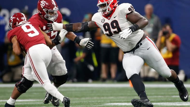 Alabama quarterback Bryce Young (9) avoids Georgia's Jordan Davis (99) during the SEC championship game Dec. 4 in Atlanta.

Syndication Online Athens