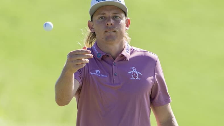 January 9, 2022; Maui, Hawaii, USA; Cameron Smith tosses his ball to his caddie on the first hole during the final round of the Sentry Tournament of Champions golf tournament at Kapalua Resort - The Plantation Course. Mandatory Credit: Kyle Terada-USA TODAY Sports
