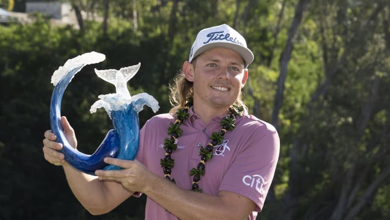 January 9, 2022; Maui, Hawaii, USA; Cameron Smith hoists the trophy after winning during the final round of the Sentry Tournament of Champions golf tournament at Kapalua Resort - The Plantation Course. Mandatory Credit: Kyle Terada-USA TODAY Sports