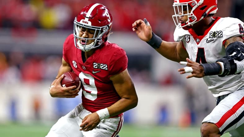 Jan 10, 2022; Indianapolis, IN, USA; Alabama Crimson Tide quarterback Bryce Young (9) runs the ball against Georgia Bulldogs linebacker Nolan Smith (4) during the second half in the 2022 CFP college football national championship game at Lucas Oil Stadium. Mandatory Credit: Mark J. Rebilas-USA TODAY Sports