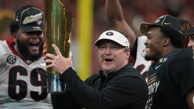 Jan 10, 2022; Indianapolis, IN, USA; Georgia Bulldogs head coach Kirby Smart holds the National Championship trophy after defeating the Alabama Crimson Tide in the 2022 CFP college football national championship game at Lucas Oil Stadium. Mandatory Credit: Kirby Lee-USA TODAY Sports