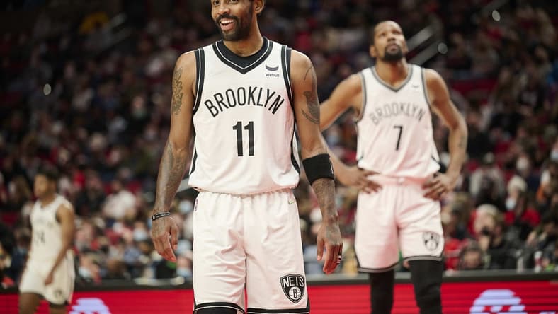 Jan 10, 2022; Portland, Oregon, USA; Brooklyn Nets guard Kyrie Irving (11) and forward Kevin Durant (7) make their way on the court after a time out during the second half against the Portland Trail Blazers at Moda Center. The Trail Blazers won the game 114-108. Mandatory Credit: Troy Wayrynen-USA TODAY Sports