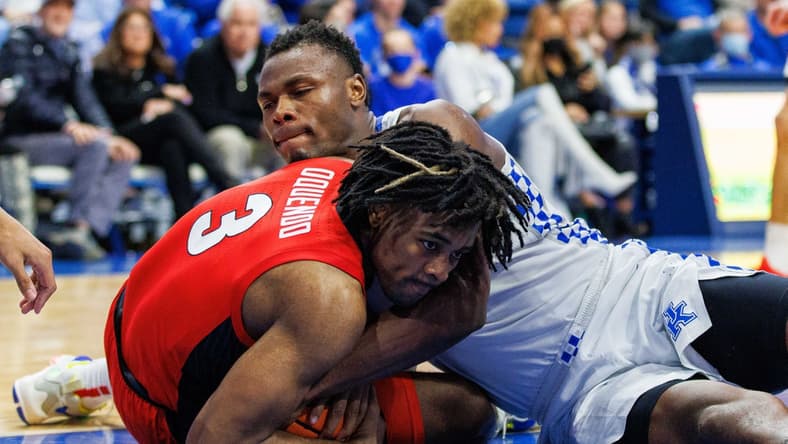 Jan 8, 2022; Lexington, Kentucky, USA; Georgia Bulldogs guard Kario Oquendo (3) and Kentucky Wildcats forward Oscar Tshiebwe (34) fight for the ball during the second half at Rupp Arena at Central Bank Center. Mandatory Credit: Jordan Prather-USA TODAY Sports