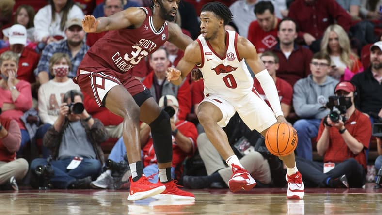 Jan 18, 2022; Fayetteville, Arkansas, USA; Arkansas Razorbacks guard Stanley Umude (0) drives against South Carolina Gamecocks forward Josh Gray (33) during the first half at Bud Walton Arena. Mandatory Credit: Nelson Chenault-USA TODAY Sports