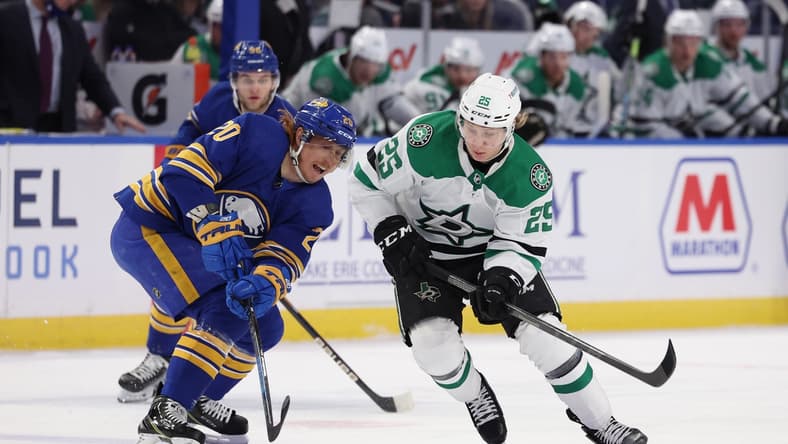 Jan 20, 2022; Buffalo, New York, USA; Dallas Stars left wing Joel Kiviranta (25) watches as Buffalo Sabres center Cody Eakin (20) looks to control the puck during the first period at KeyBank Center. Mandatory Credit: Timothy T. Ludwig-USA TODAY Sports